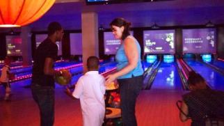 Alicia bowling with Family Center youths. Recreational activities is a good way to reduce stress. 